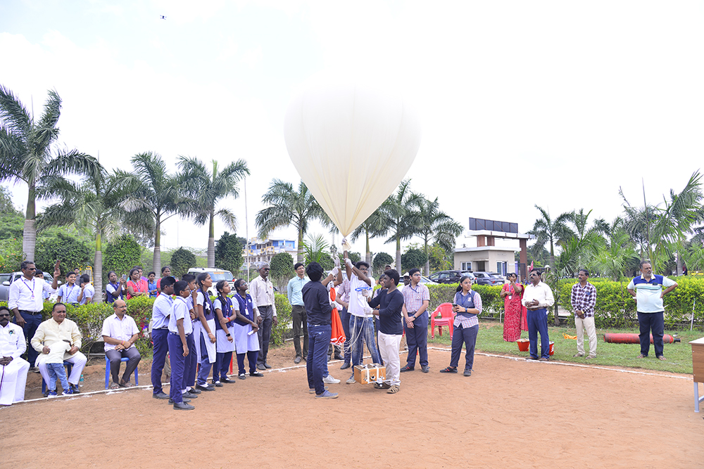 Happy Subham Vidyashram School boy child seated in a classroom looking up and smiling.